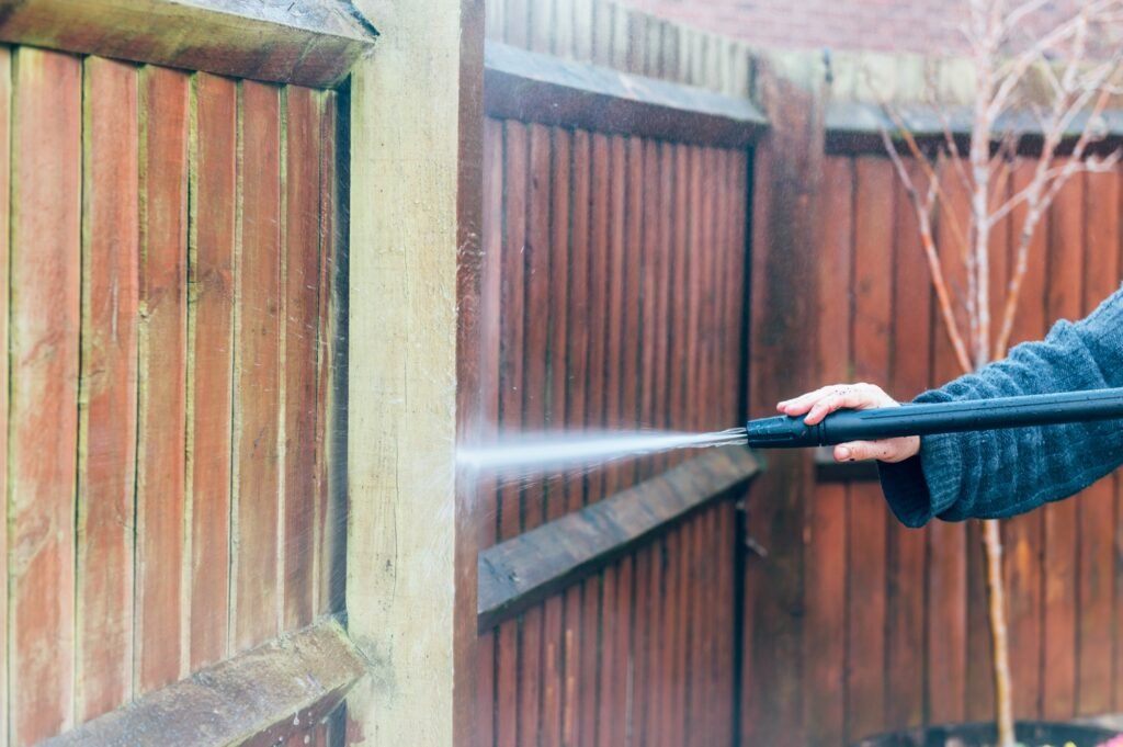 cleaning of wood fence with pressure washer